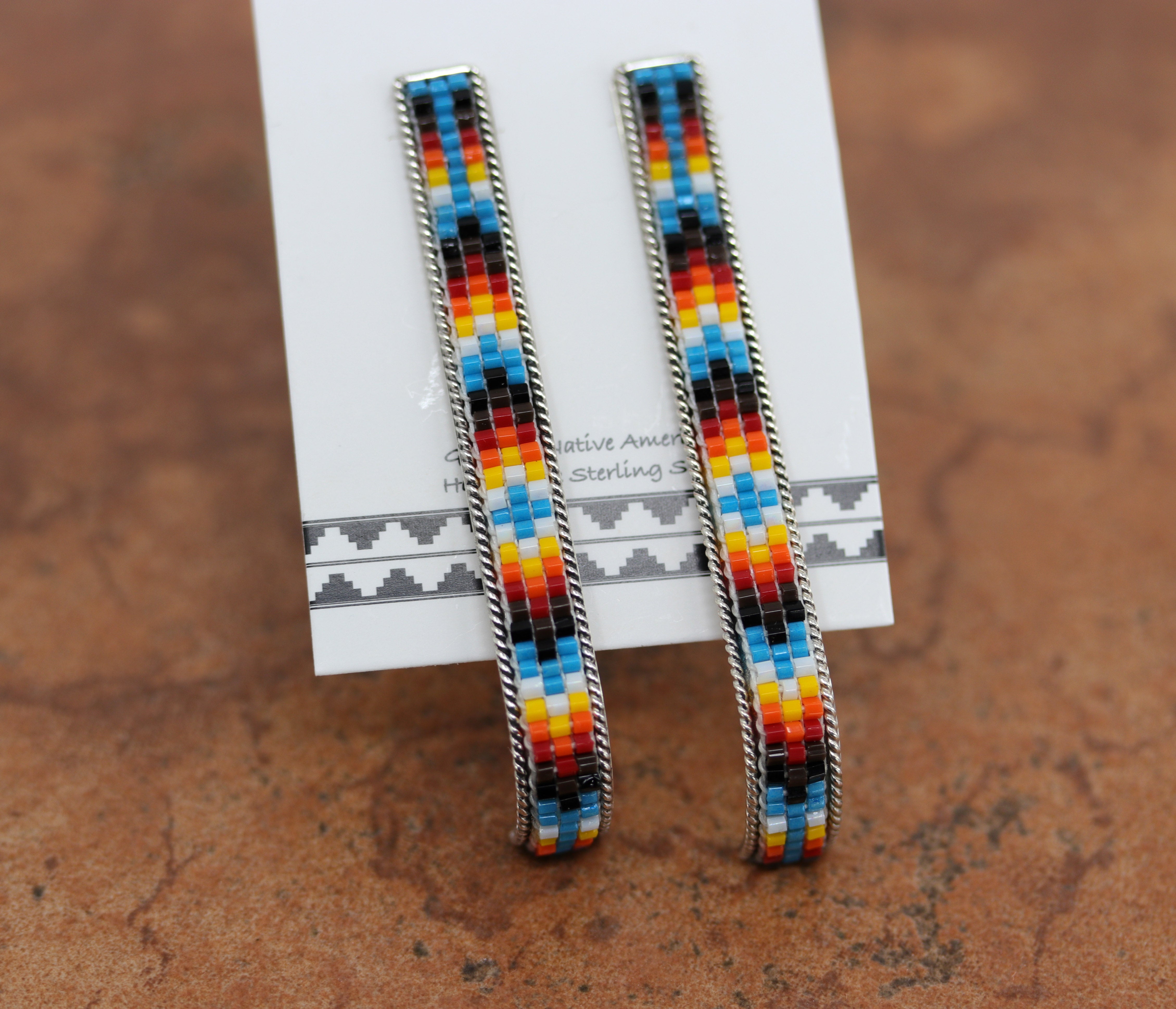 Lovely Navajo Silver Blue Beaded Post Earrings. They are made from sterling silver and beads. The earrings about 2 1/2" long and 1/4" in width.