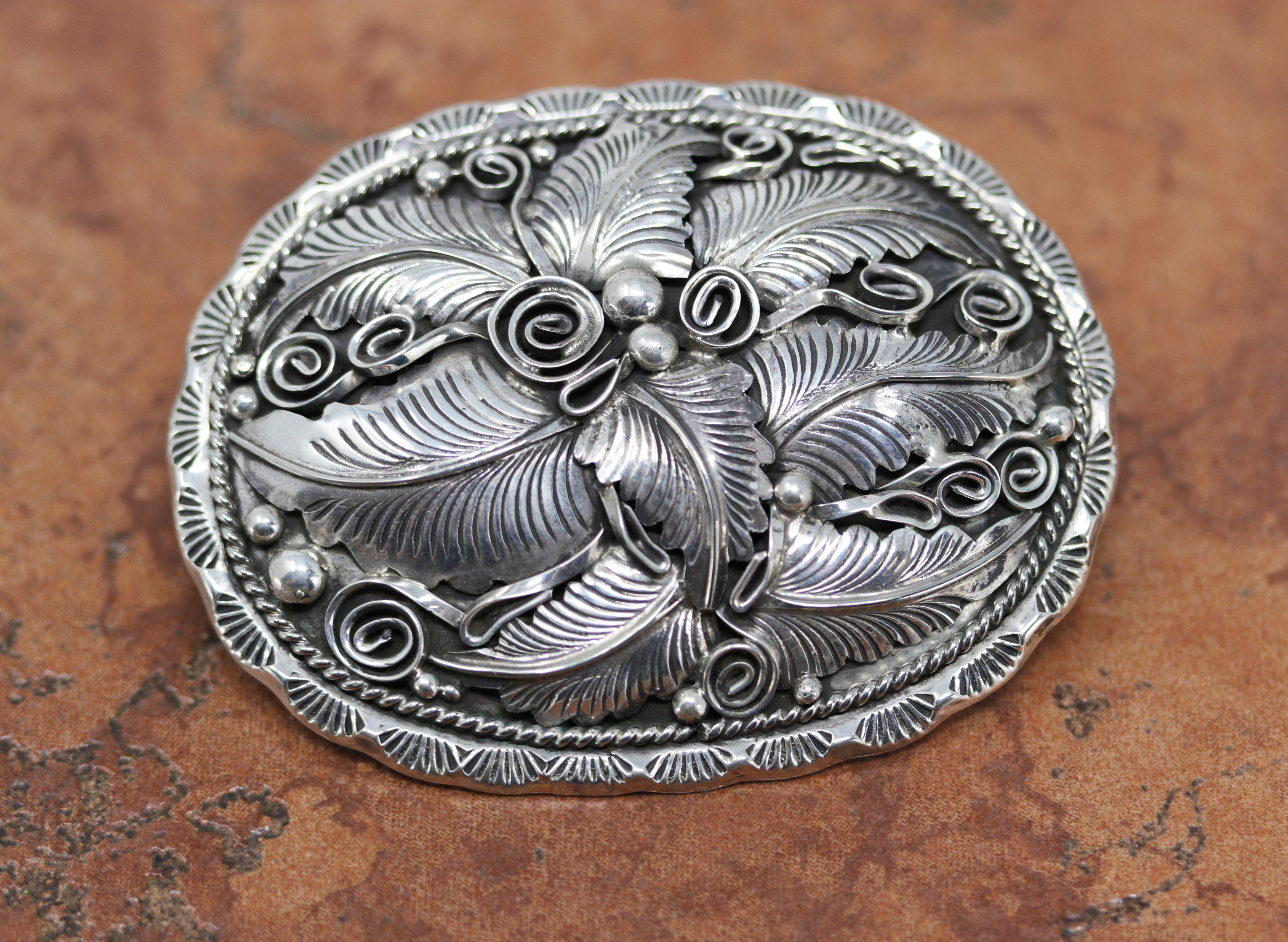 Navajo Native American Belt Buckle. It is made from sterling silver. It is about 3 1/2" by 2 3/4". It will hold a belt up to 1 1/2" wide.