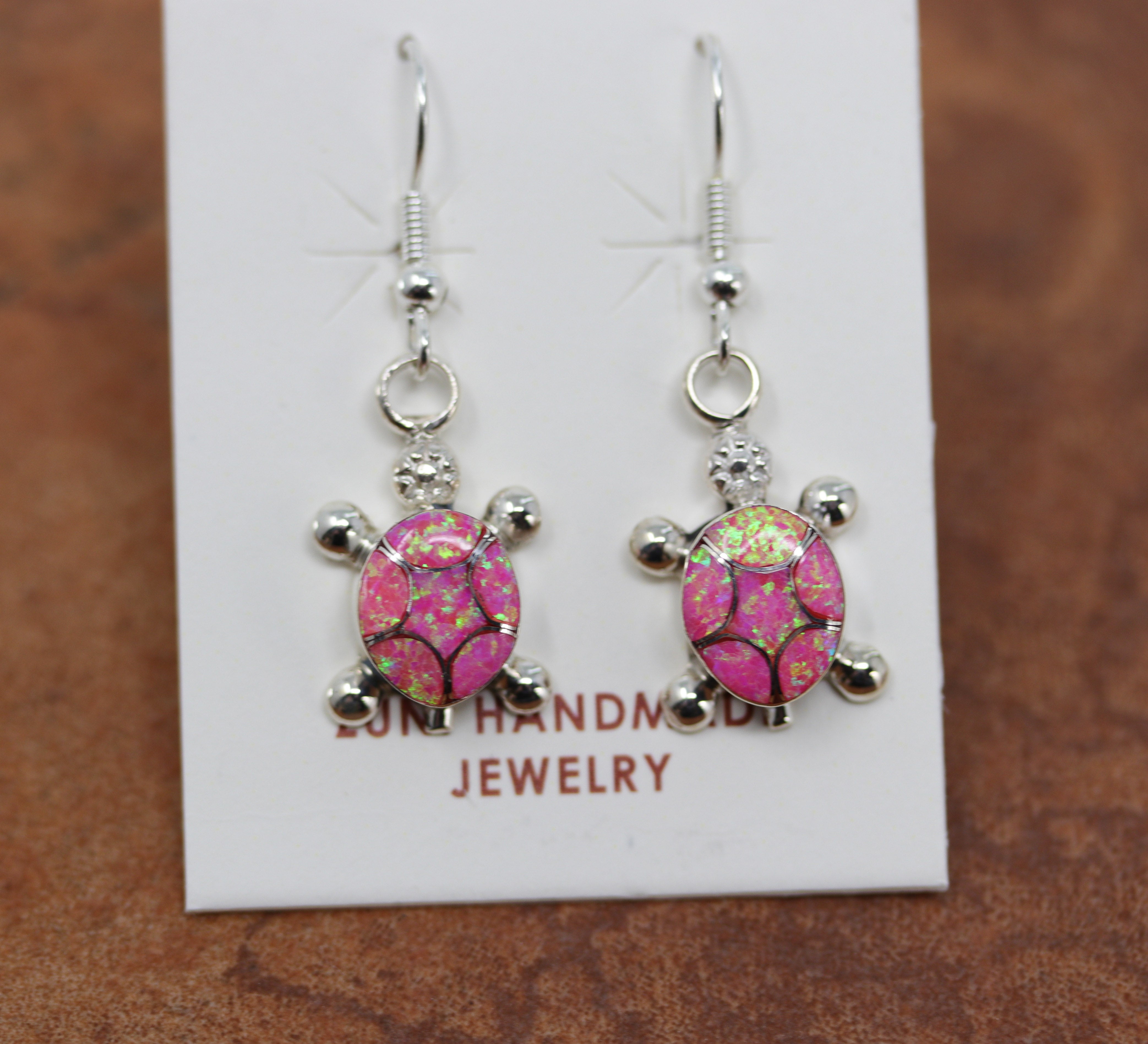 Silver turtle shaped earrings made from pink opal gemstones